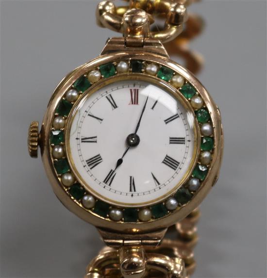 An early 20th century 9ct gold gem set manual wind wrist watch on a 9ct gold expanding bracelet.